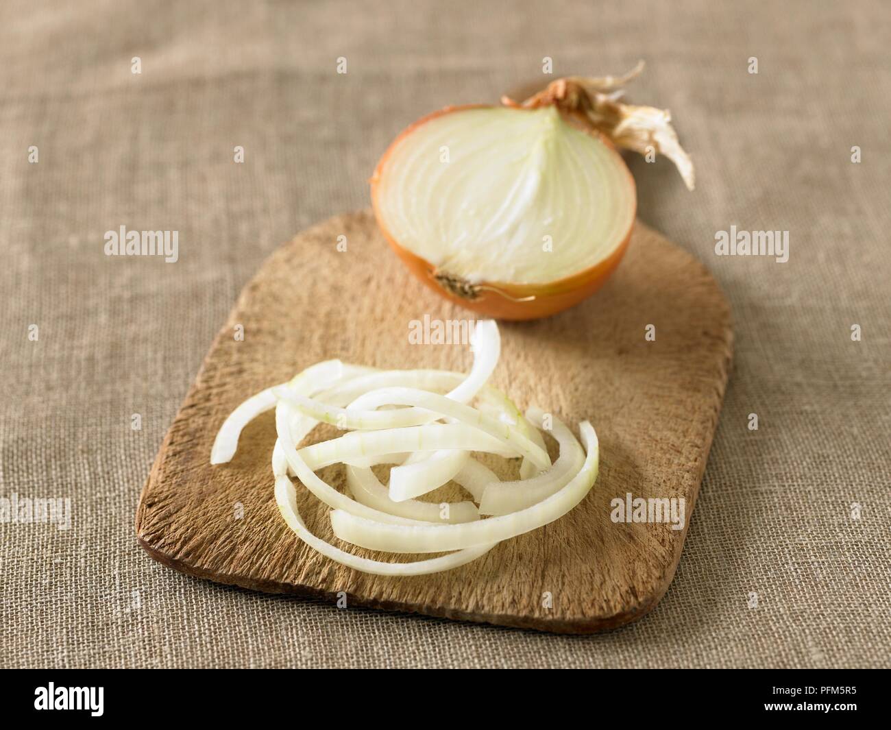 Sliced onion on chopping board. Stock Photo