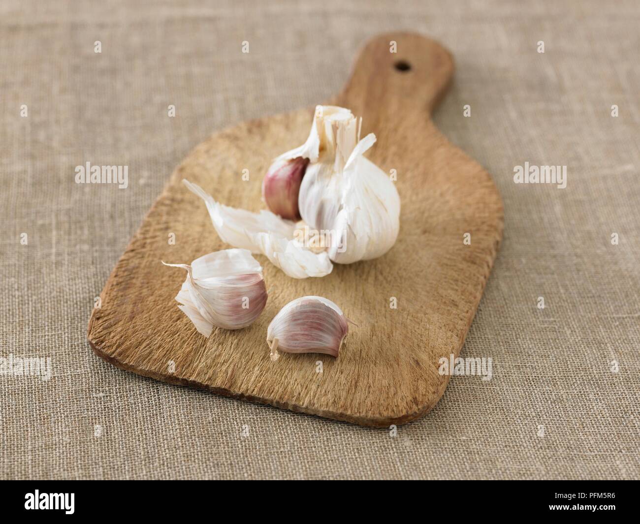 Garlic on chopping board Stock Photo