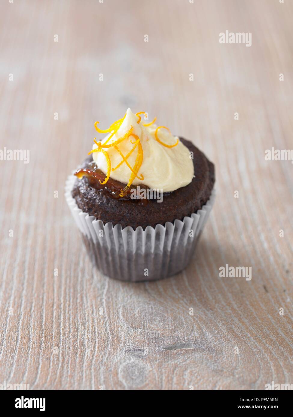 Chocolate sponge cupcake with icing on top Stock Photo