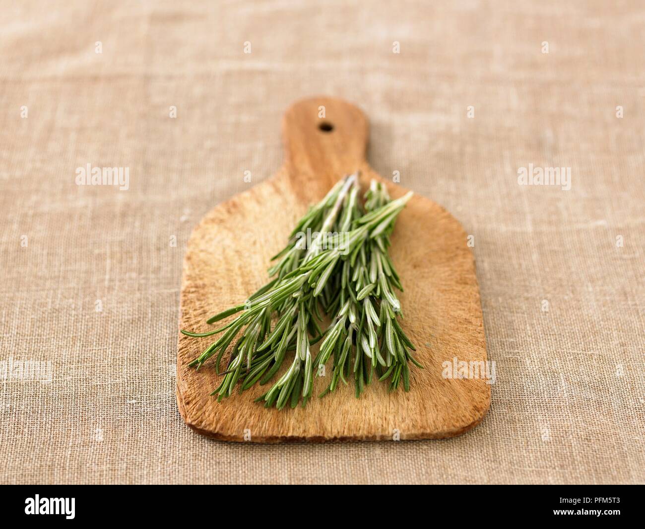 Fresh rosemary on chopping board. Stock Photo