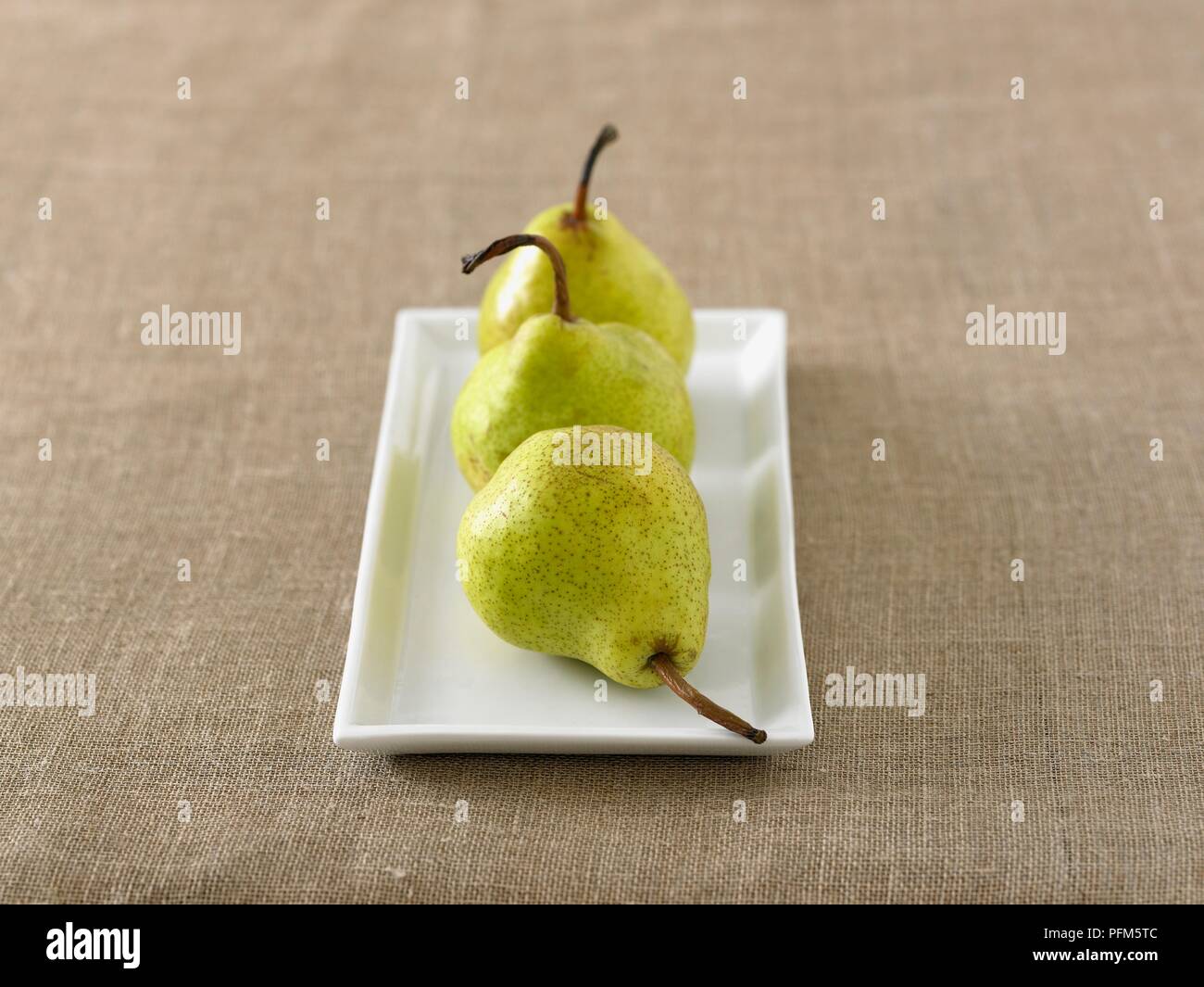 Three pears on a rectangular plate Stock Photo