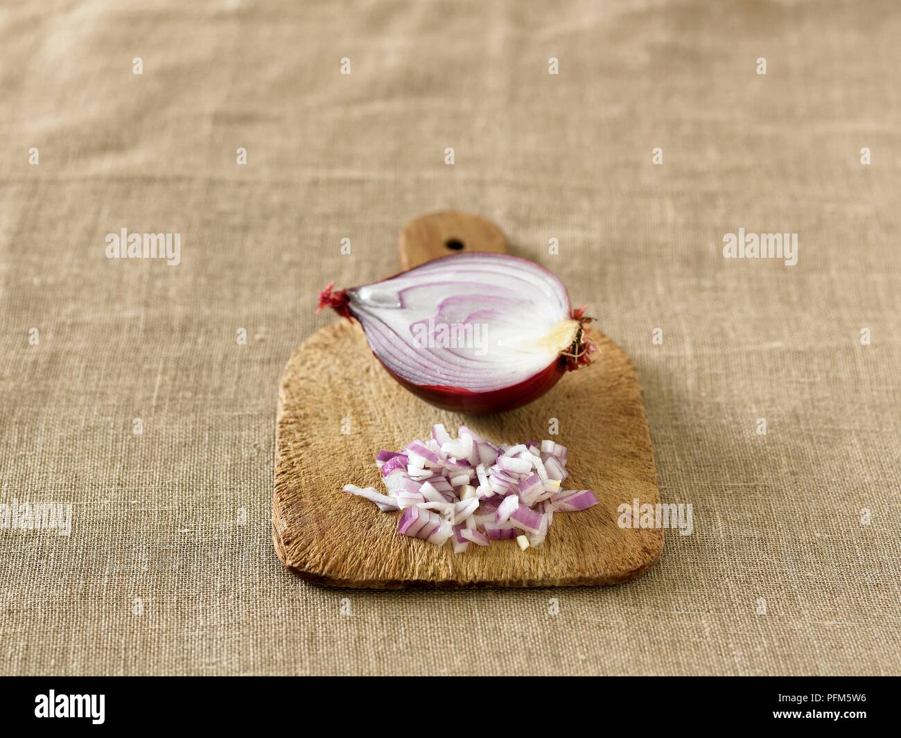 Sliced and chopped red onion on chopping board Stock Photo