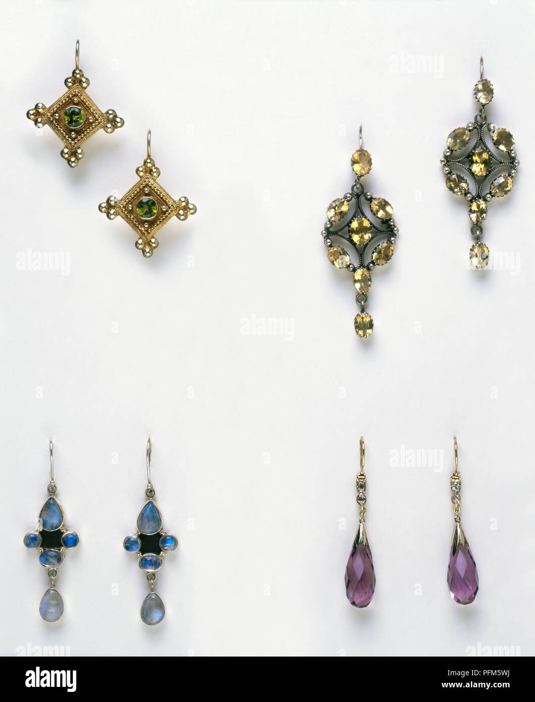 Pairs of zircon earrings, verdelite tourmaline earrings, pendeloque-cut amethyst earrings, and moonstone earrings Stock Photo