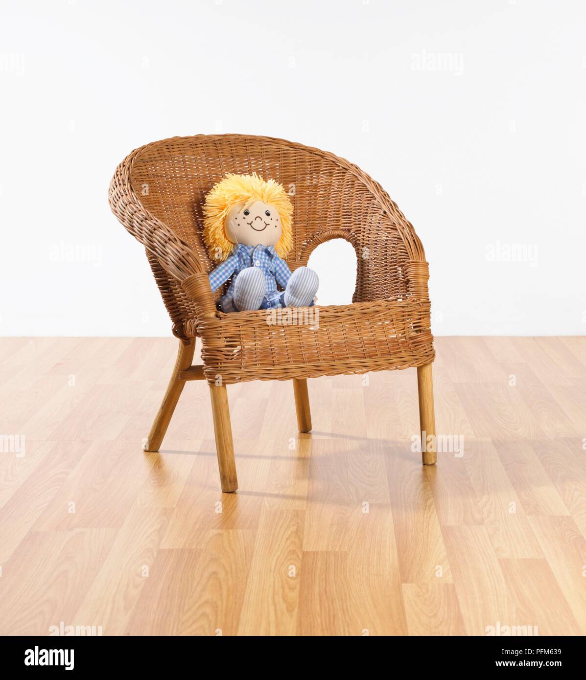 Doll on wicker chair Stock Photo - Alamy