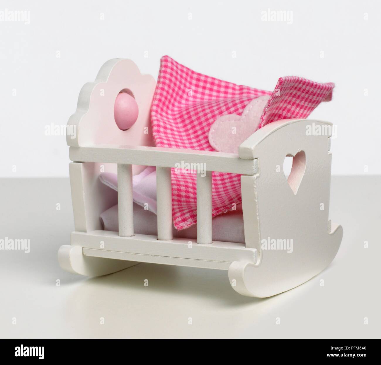 white wooden dolls cot