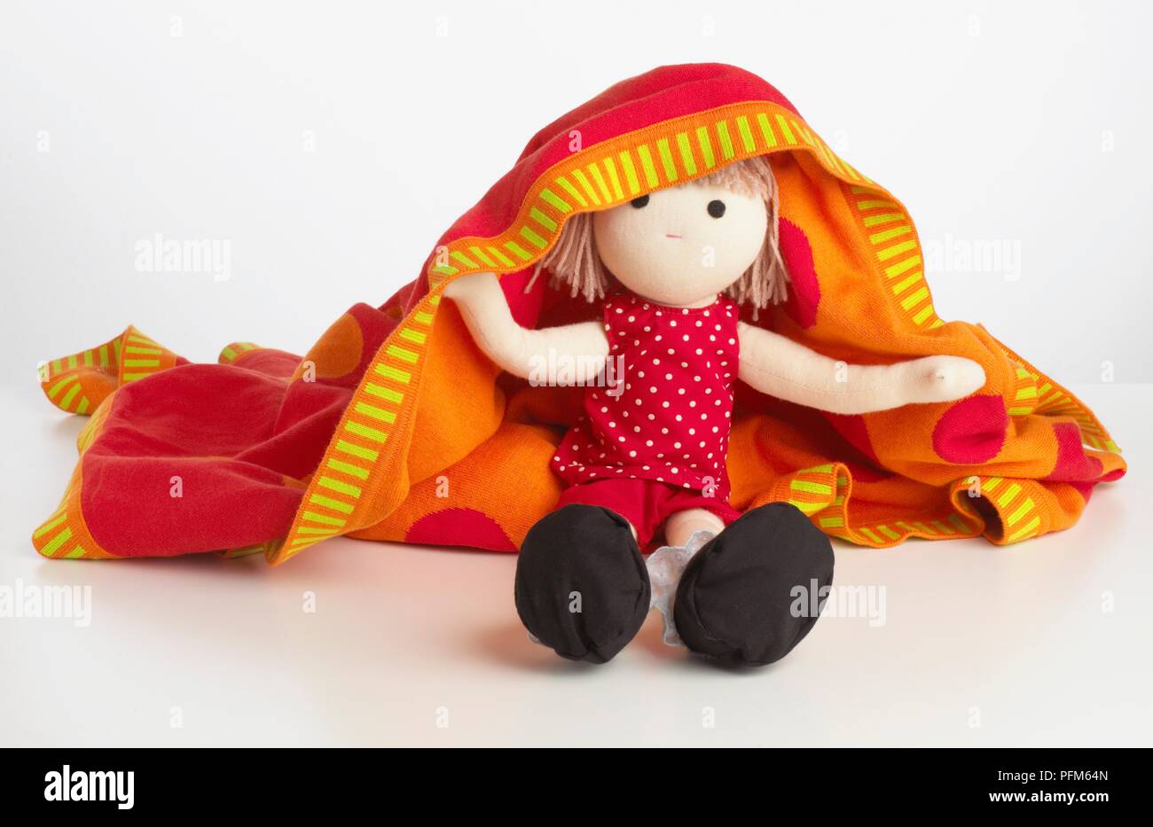 A doll covered with a blanket Stock Photo
