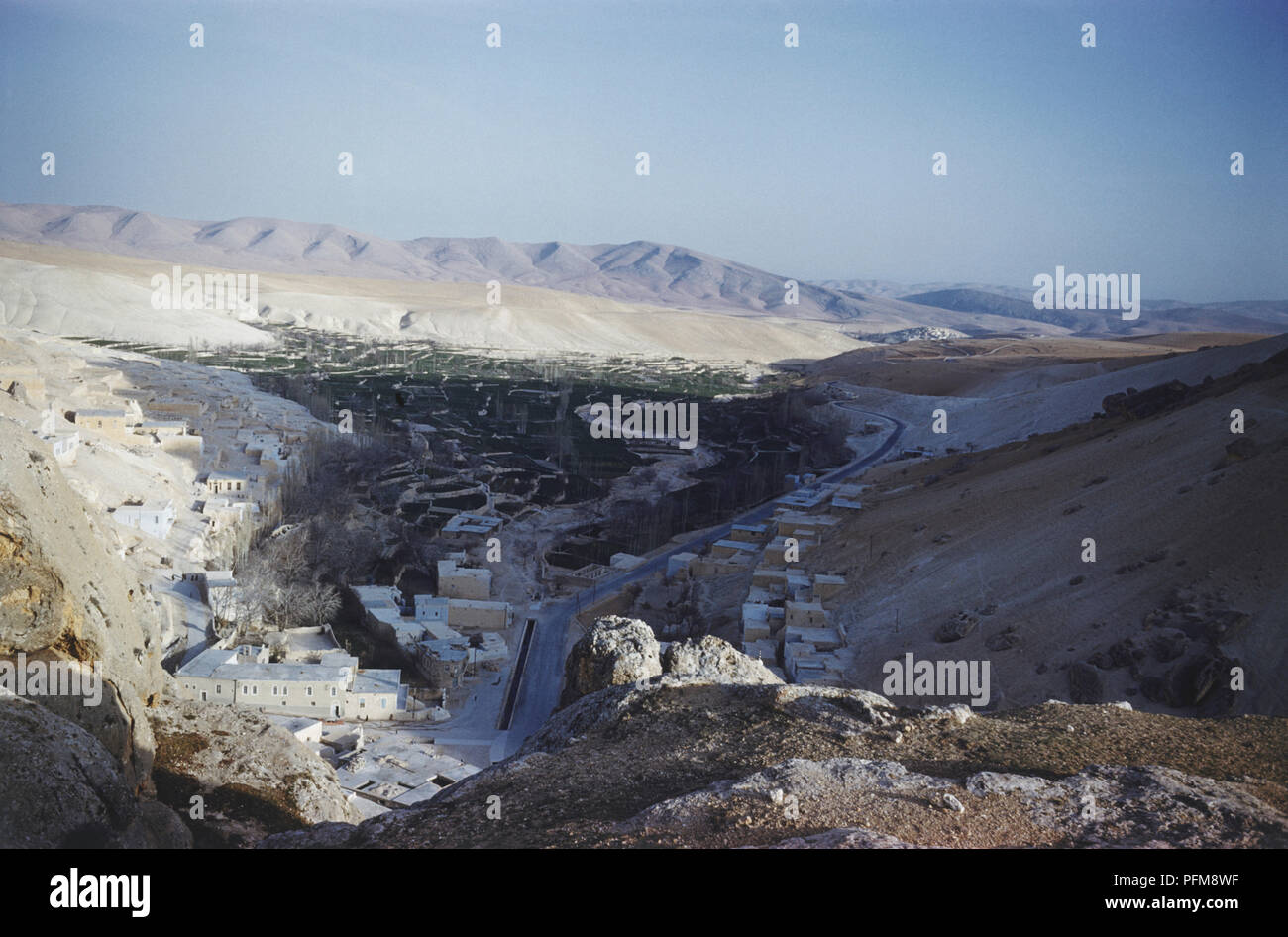 Syria, Maaloula, mountainside houses, road winding through, 56