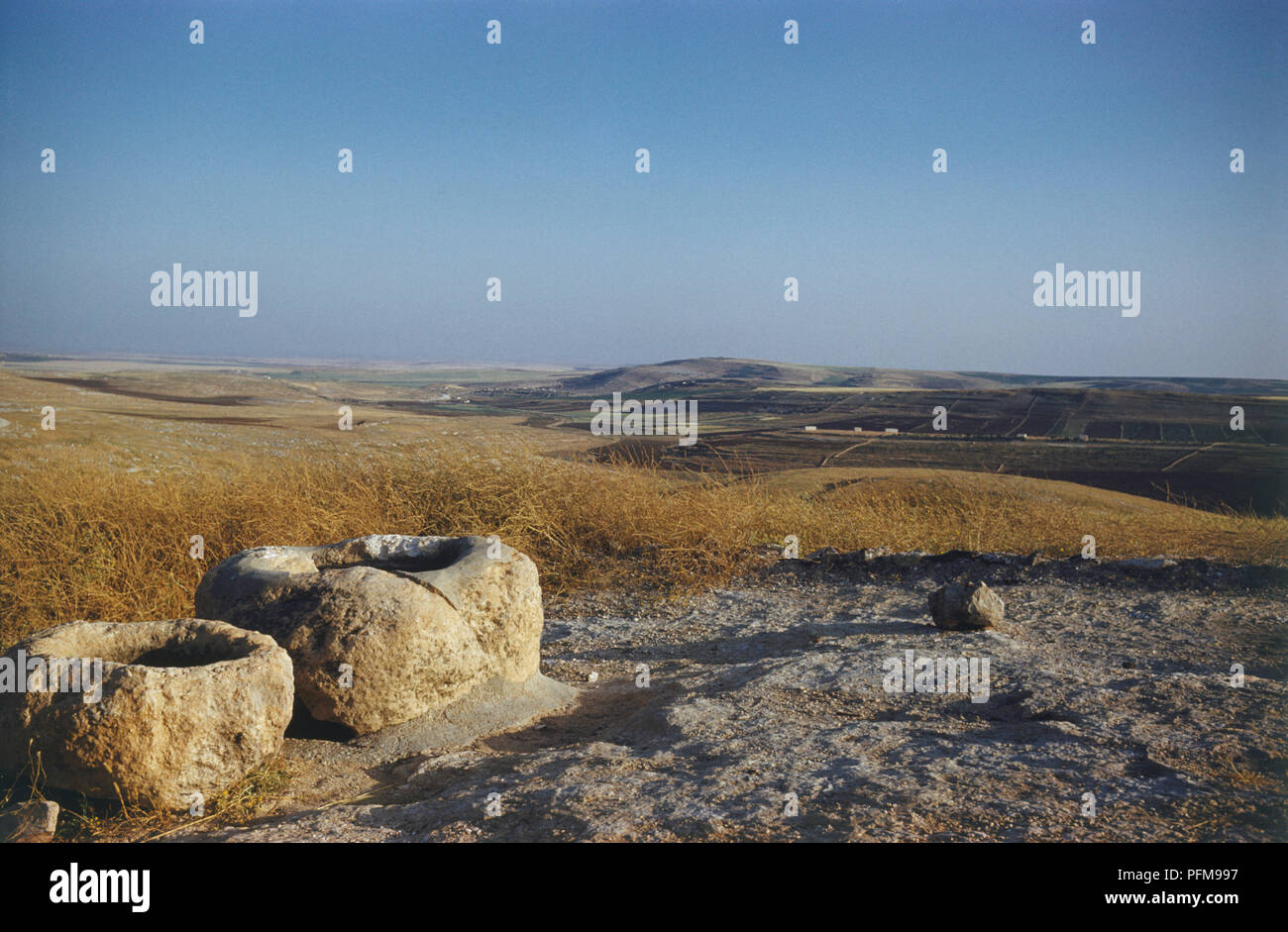 Ancient stone wells south of Amman, Jordan, landscape typical of the area in background. Stock Photo