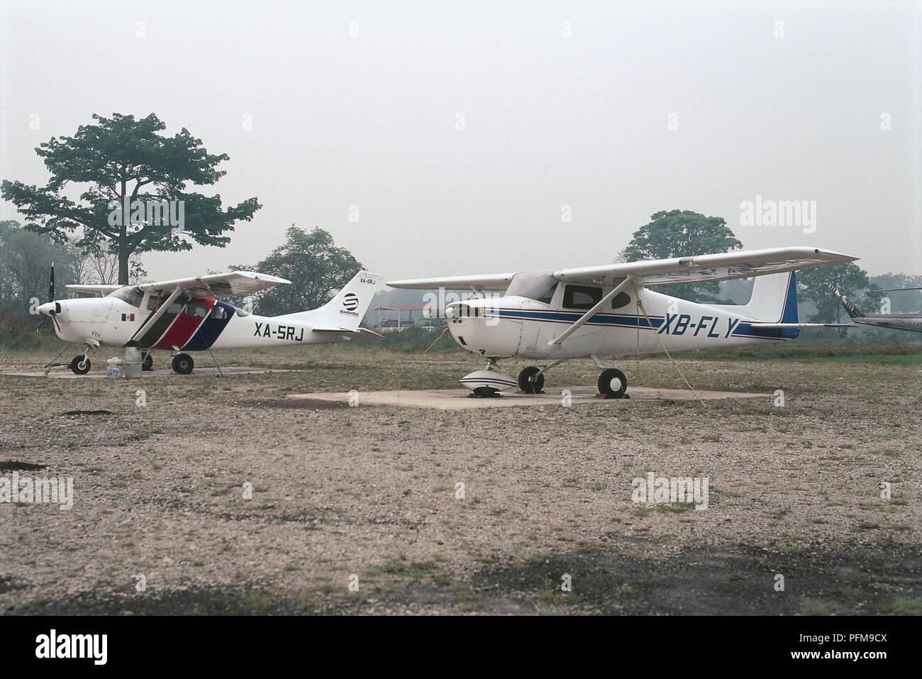 Mexico, Palenque Airport, two small, domestic propeller planes standing in sand. Stock Photo