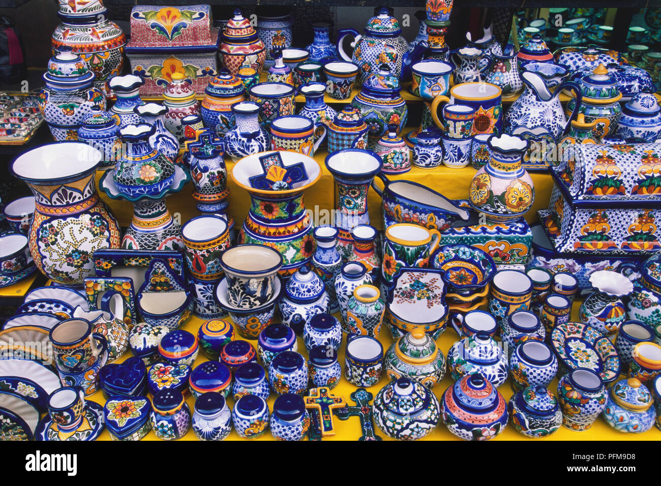 USA, Mexico, brightly coloured glazed ceramics for sale on market stall, high angle view. Stock Photo