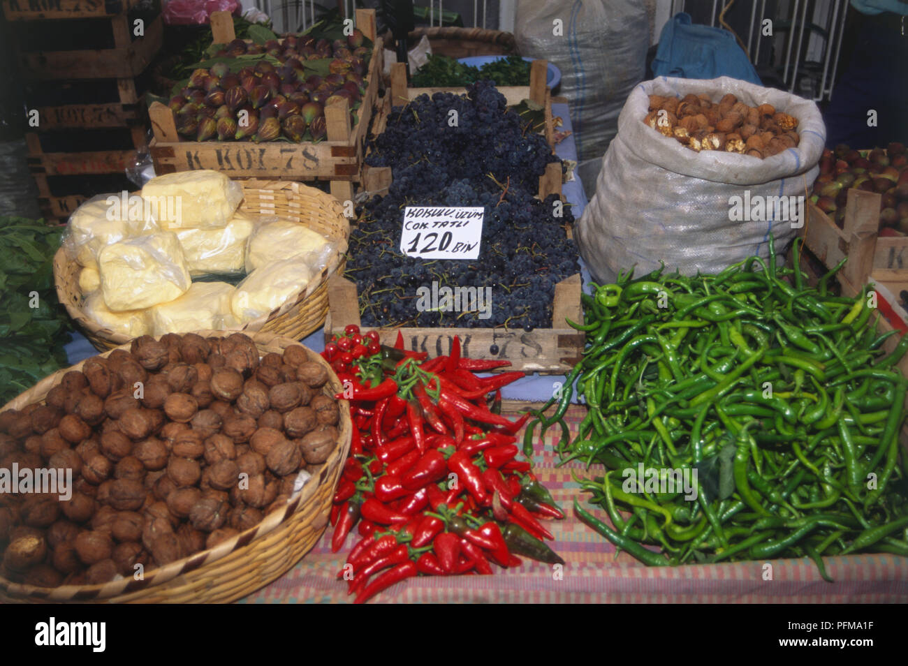 Asia, Turkey, Istanbul, Besktas Square Market, colourful array of fresh fruit and vegetables including red and green chillies, black grapes and walnuts, for sale. Stock Photo