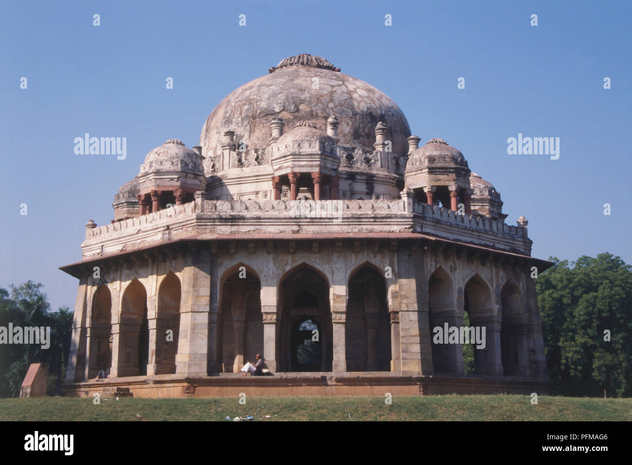 India, New Delhi, Lodi Gardens, ancient tomb of Muhammas Shah, octagonal structure with porticoed sides, dome surrounded by chhatris, jaalis once filled the spaces between the pillars, trees in background. Stock Photo