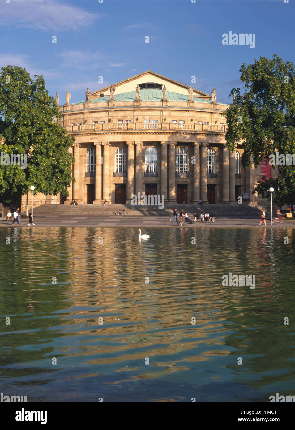 Germany, Baden-WEurttemberg, Stuttgart, view from the lake of the Neo Classical facade of Stuttgart's Staatstheater built in 1907 to 1912 by Max Littmann. A swan is on the water in the forefront of the image. Stock Photo