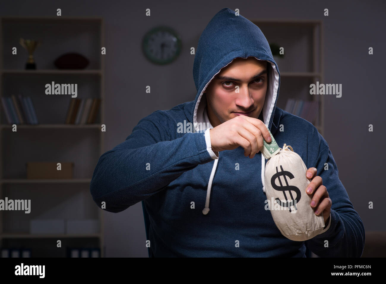Hacker with sack of money Stock Photo - Alamy