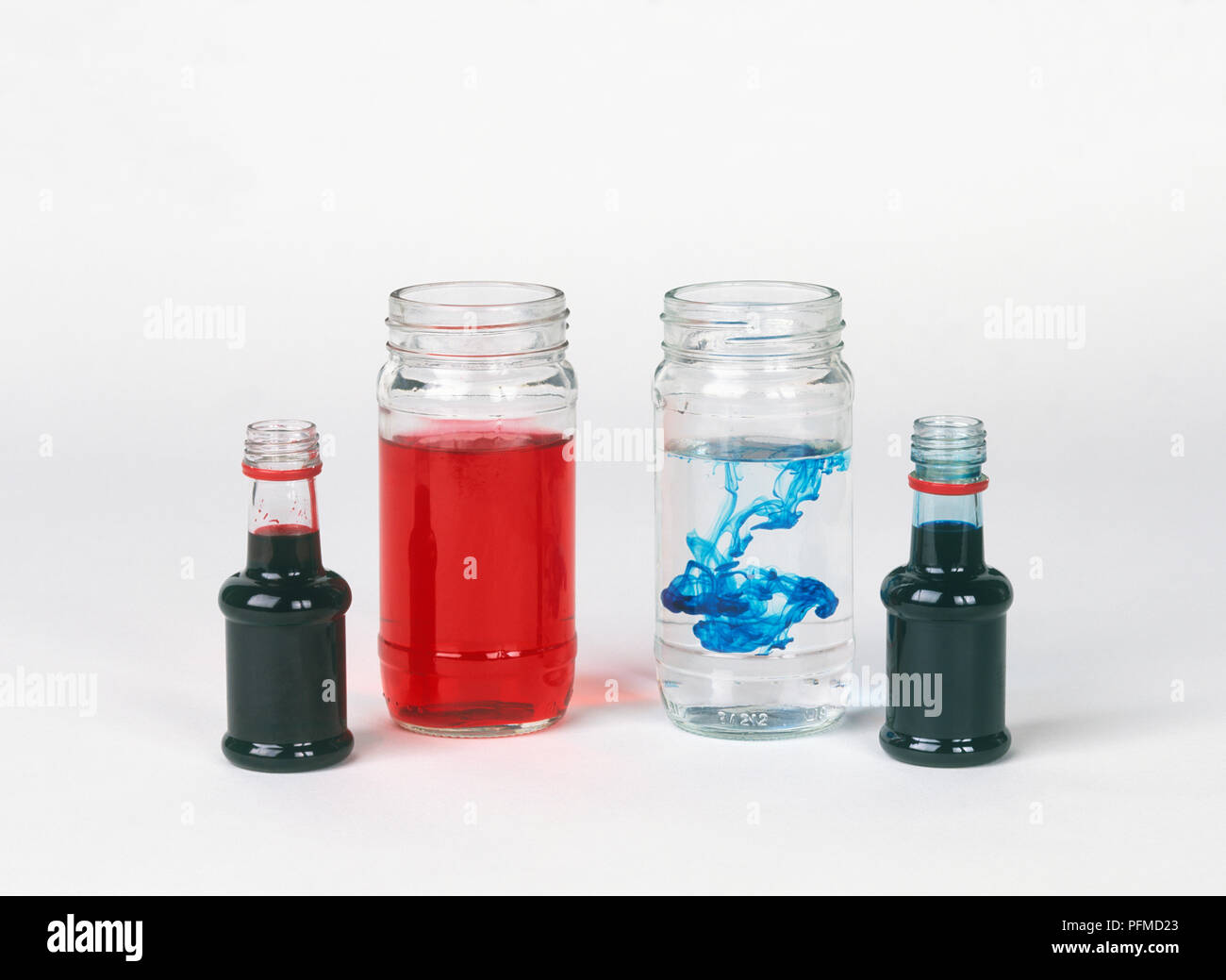 Jars and bottles containing food colouring Stock Photo