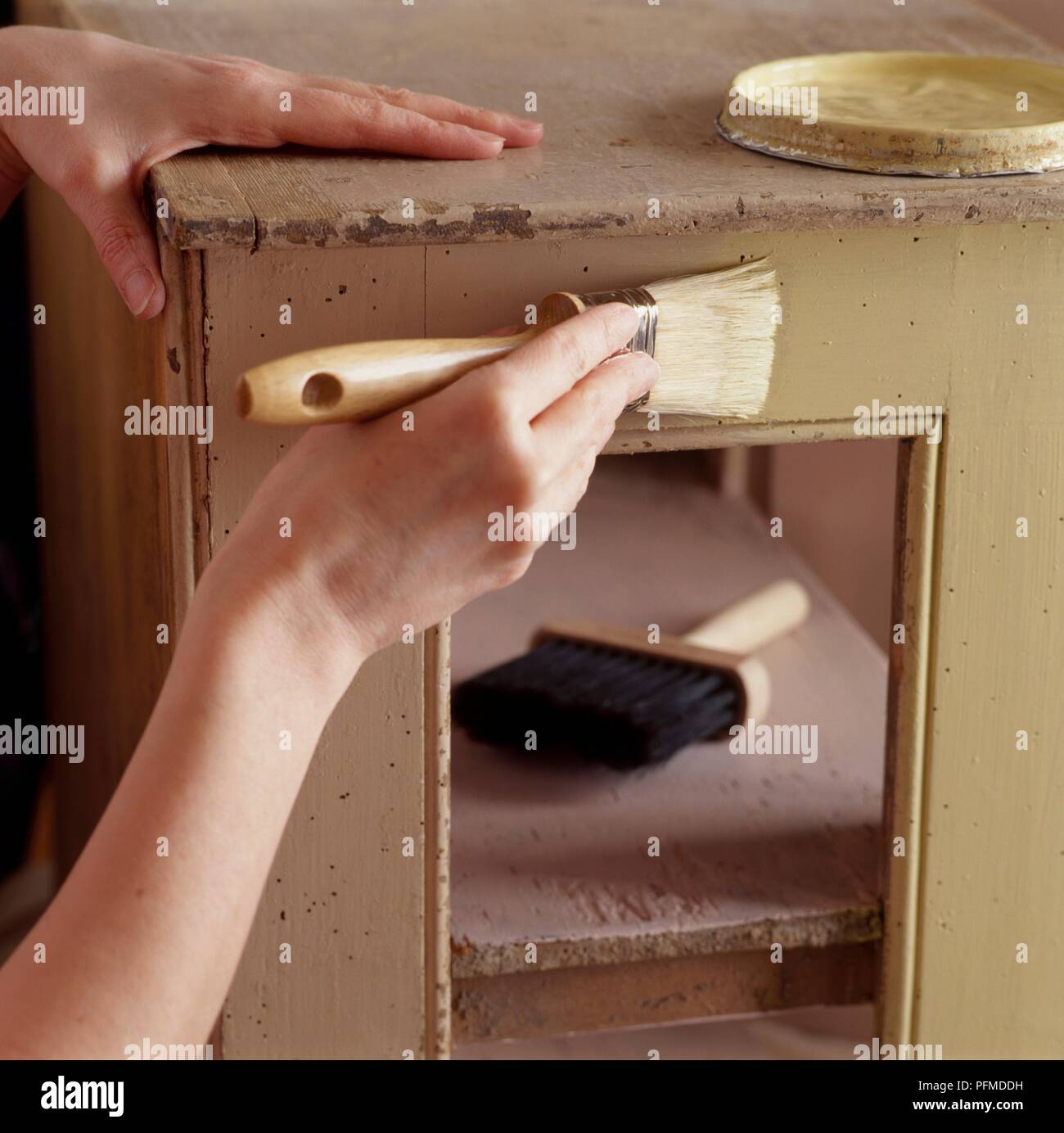 Painting old fashioned cupboard with beige paint Stock Photo Alamy