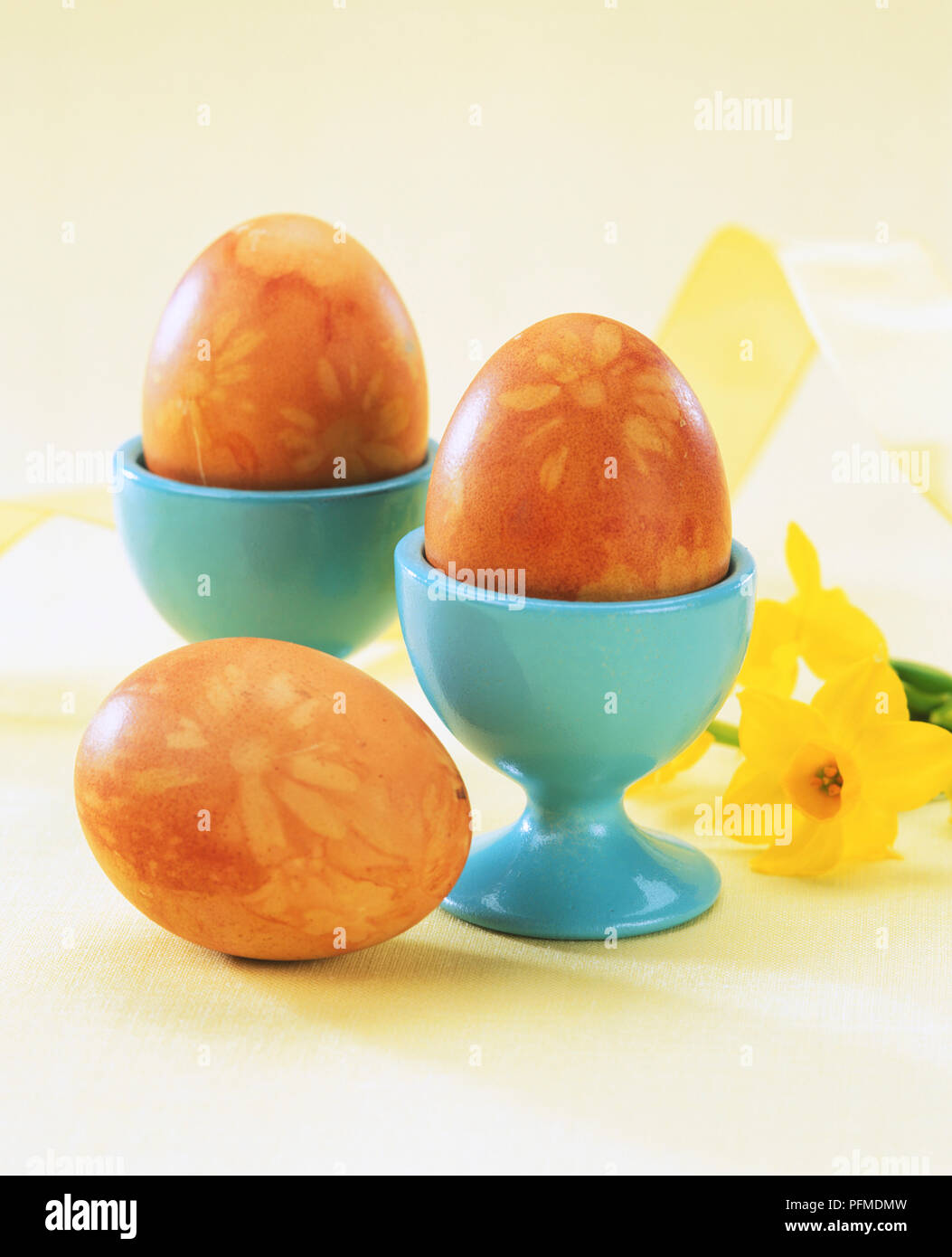 Eggs in eggcups stained with a flower design. Stock Photo