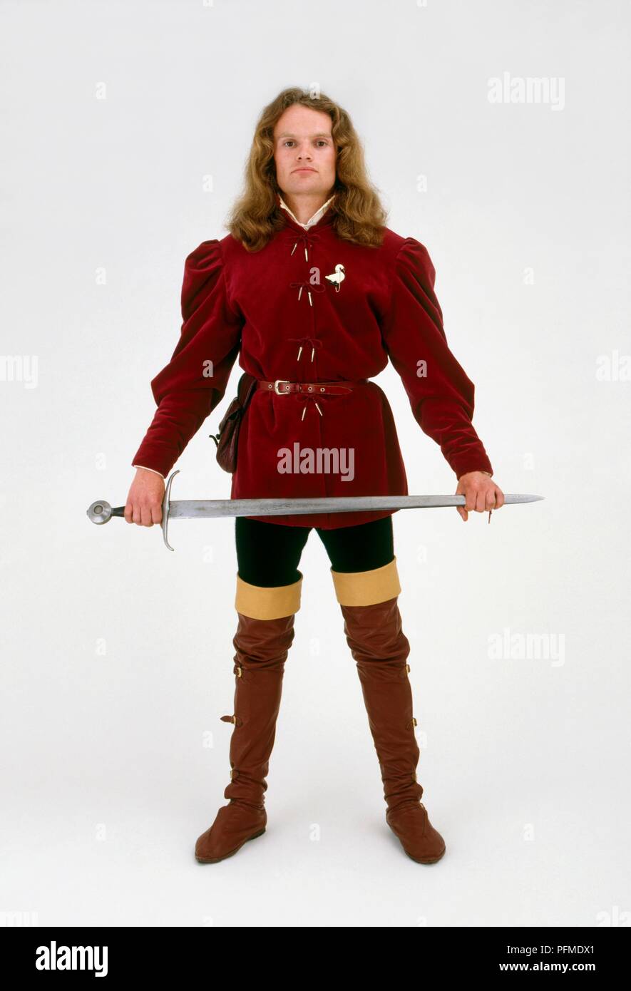 Man wearing medieval costume holding sword Stock Photo