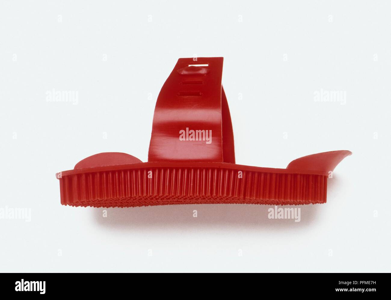 Red plastic curry comb, side view Stock Photo Alamy