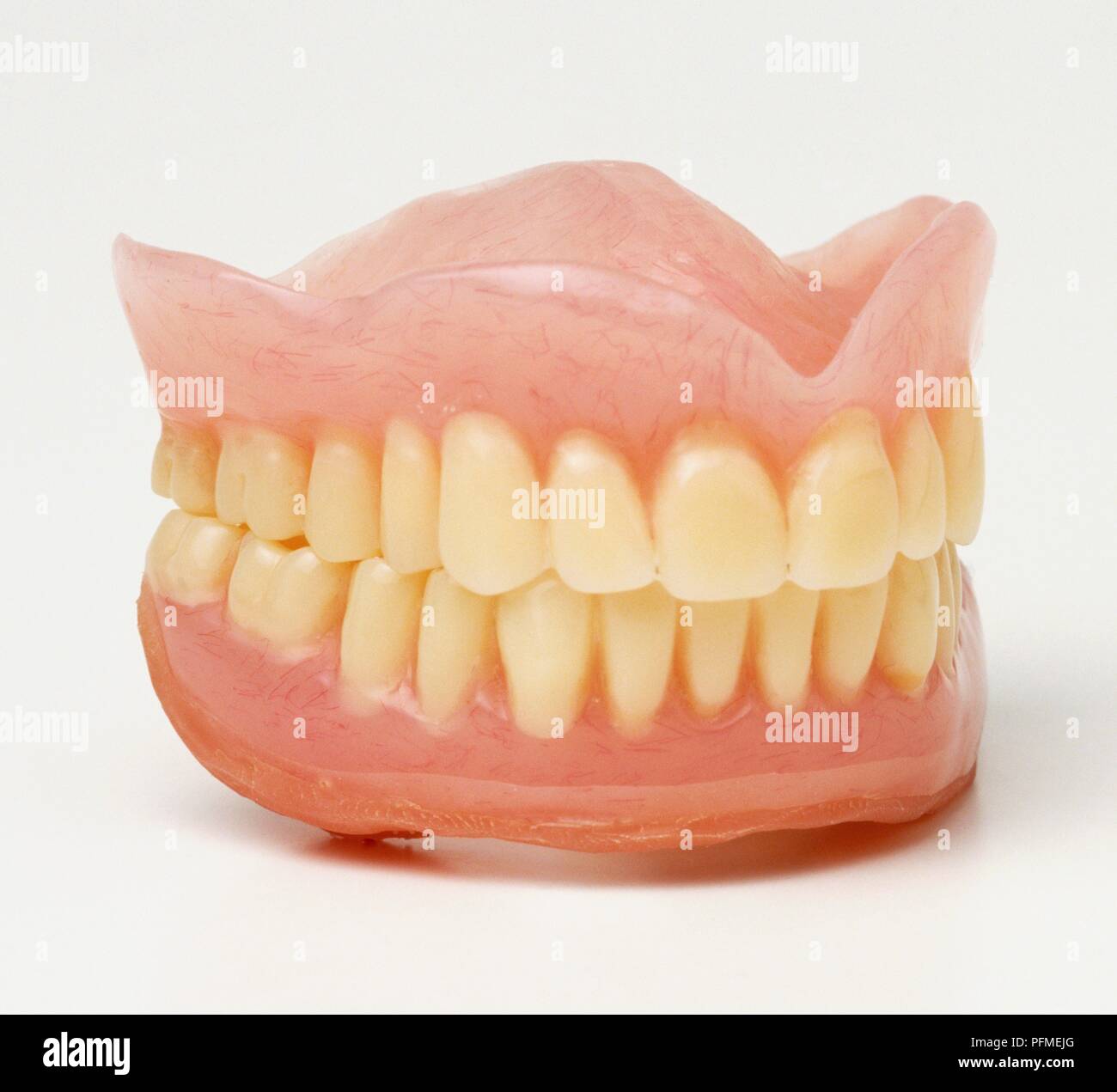 Set of false teeth, side view Stock Photo - Alamy