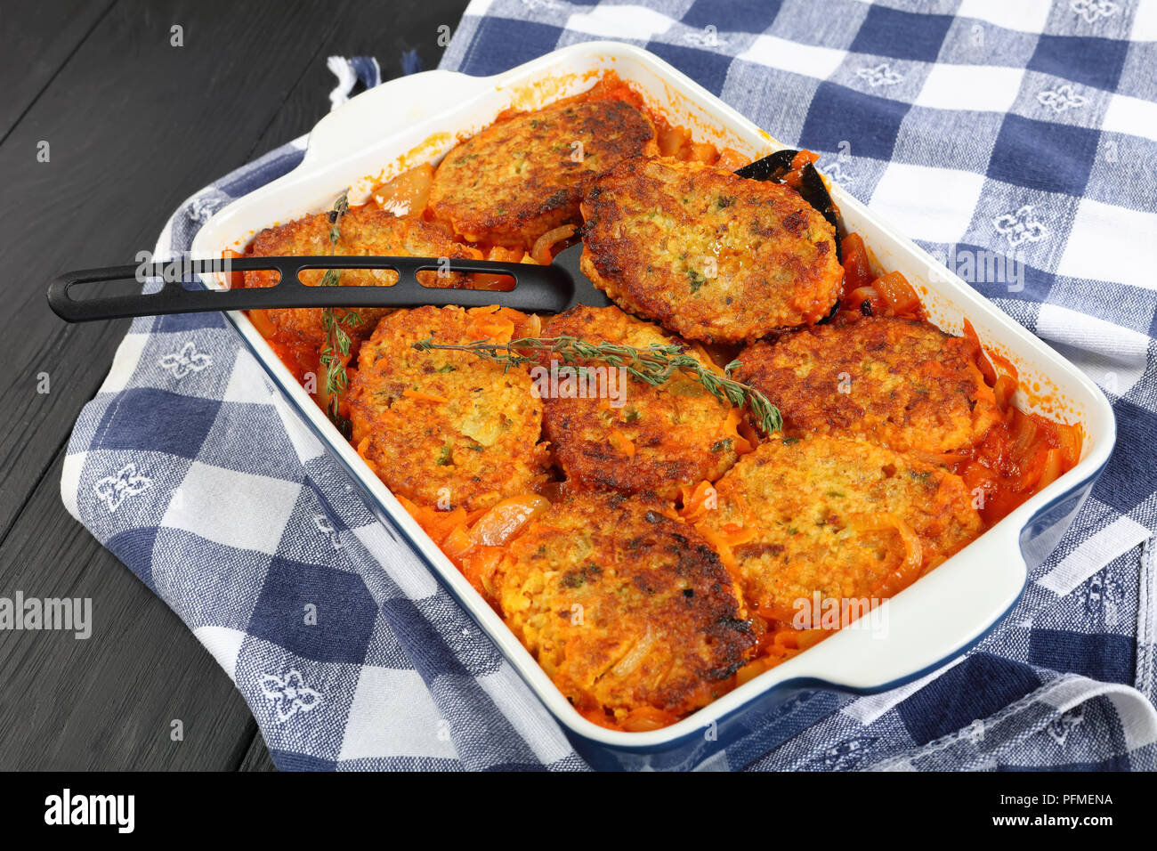 closeup of quick and easy couscous fish cakes baked in oven with onion