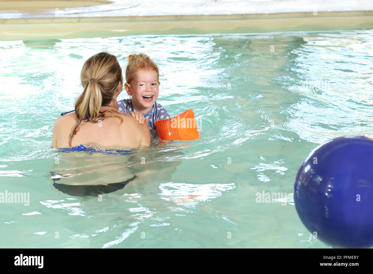 A Mother with happy daughter in a swimming pool Stock Photo