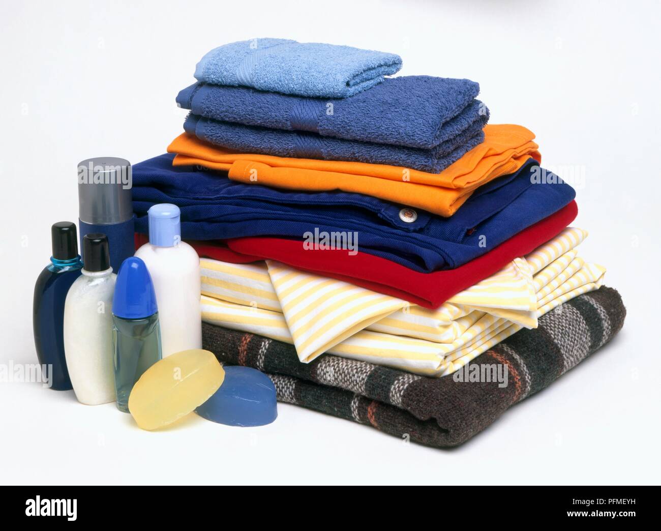 Stack of folded laundry, and personal hygiene bottles and soaps Stock Photo Alamy