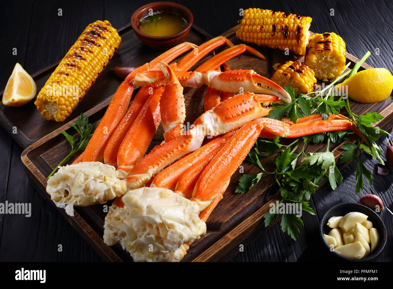 snow Crab legs served with melted butter, garlic cloves, lemon slices