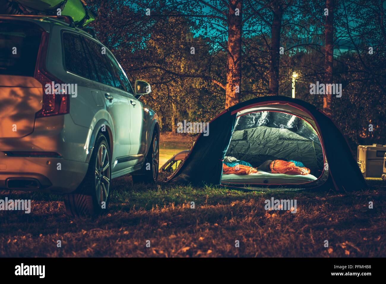 Tent Camping in the Forest. Traveling by Car and Camping with a Tent. Summer Travel Theme. Stock Photo