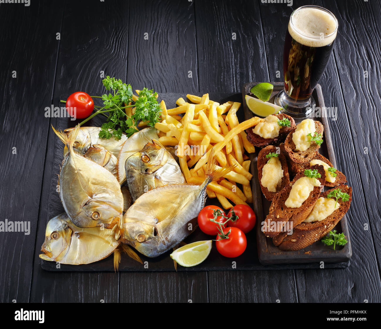 delicious cold smoked moon fish and french fries served on a black