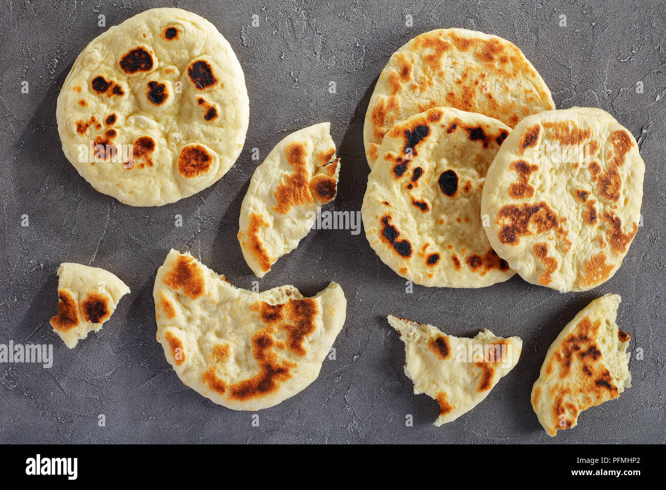 delicious soft freshly fried pita bread on concrete table, horizontal view from above Stock Photo
