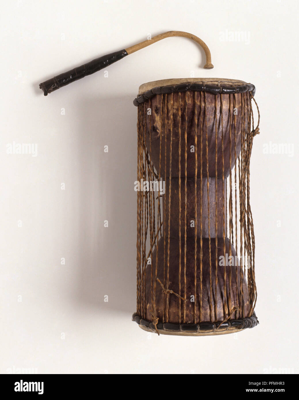 Talking drum and beater, from West Africa, closeup Stock Photo Alamy