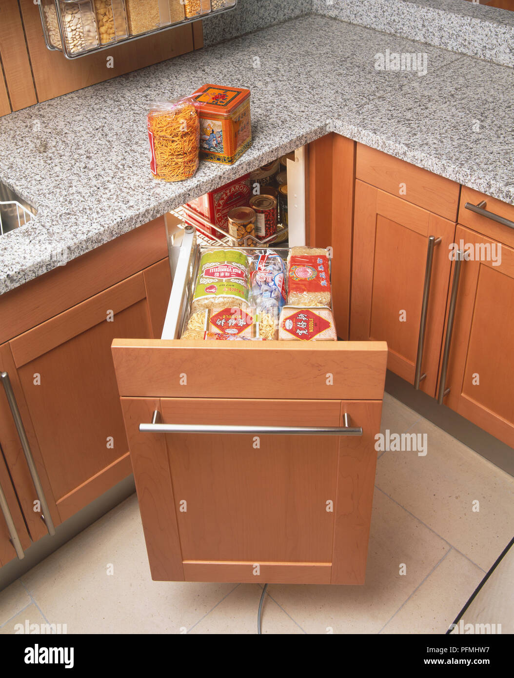 Pull out storage drawer with white dishes in modern kitchen Stock Photo -  Alamy