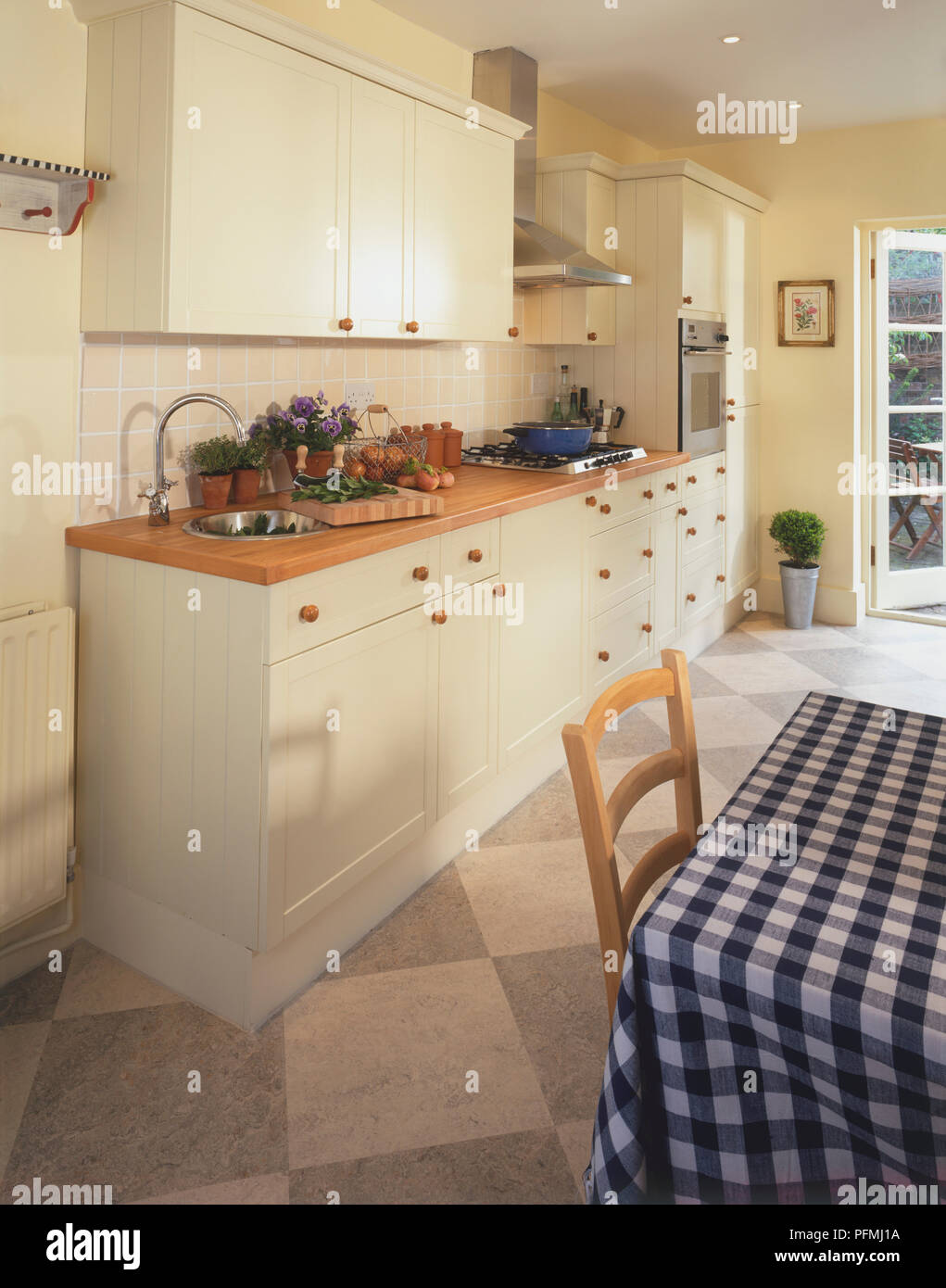 Standard fitted kitchen units in dining area. Stock Photo