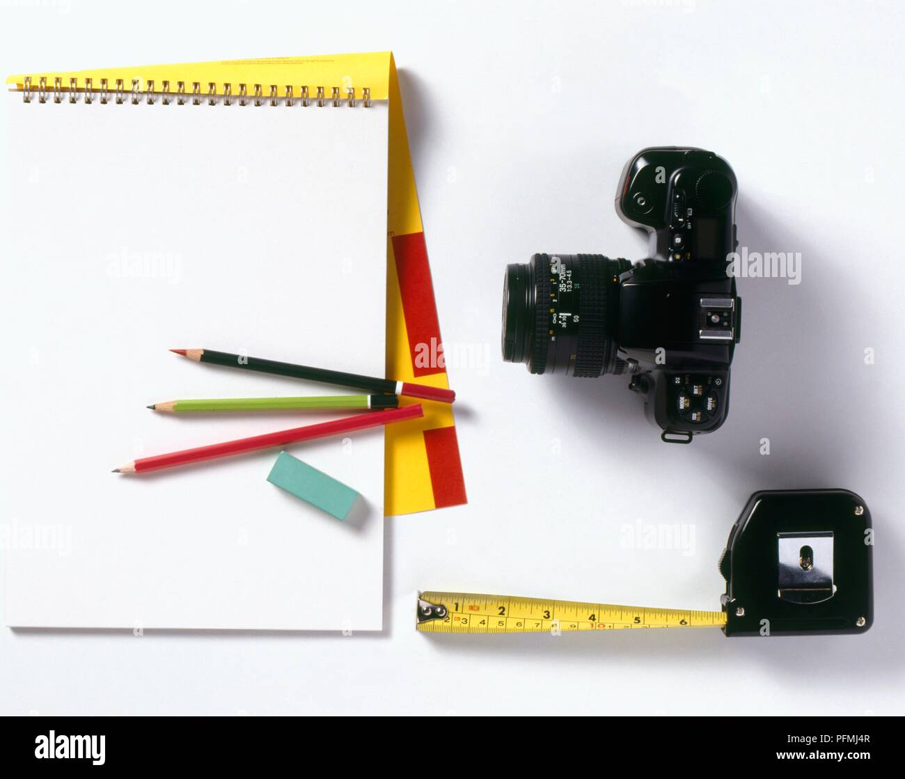 Notepad, pencils, erasers, tape measure and camera Stock Photo Alamy