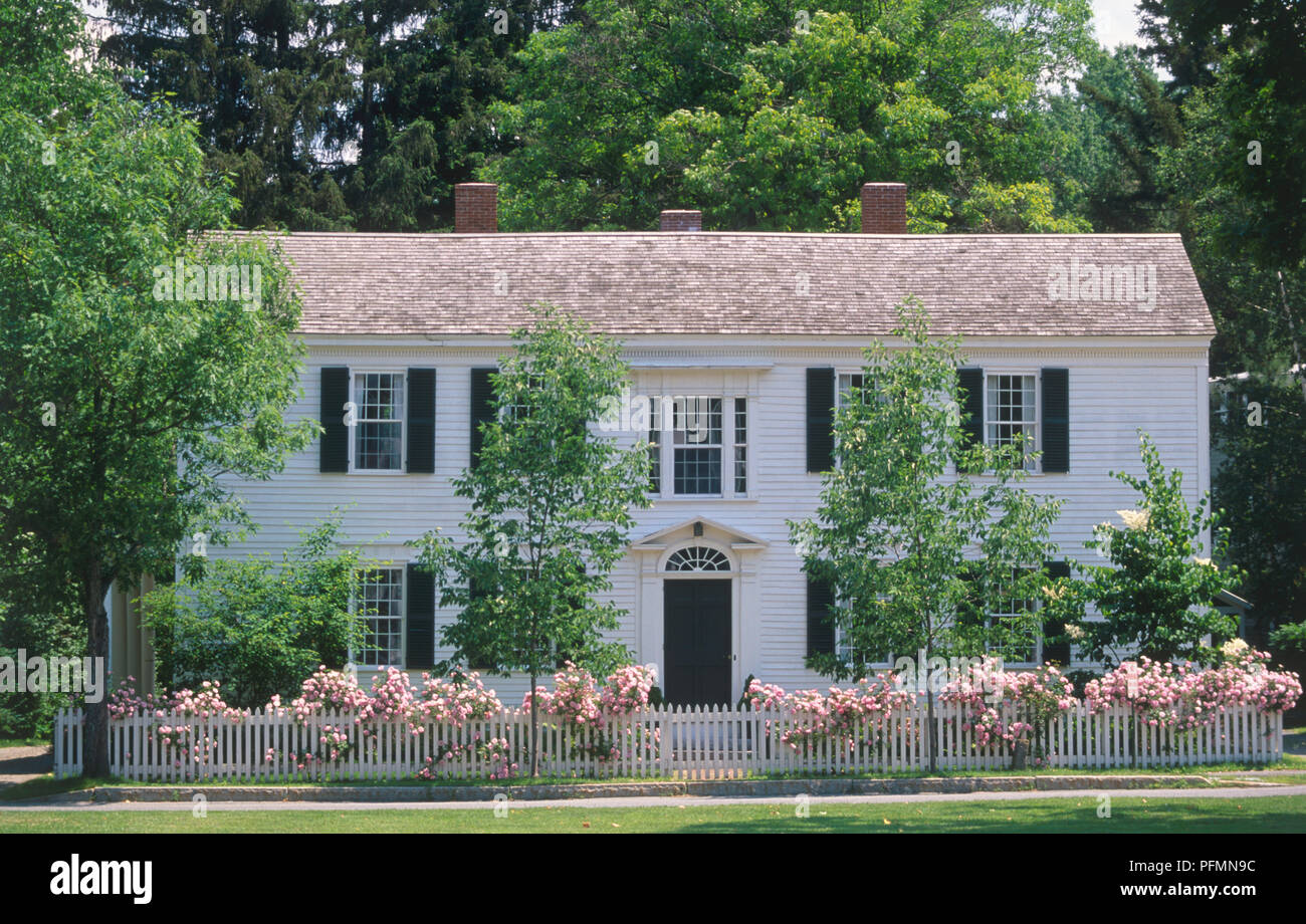 USA, New England, Vermont, Woodstock, house showing clapboard facade and white picket fence Stock Photo