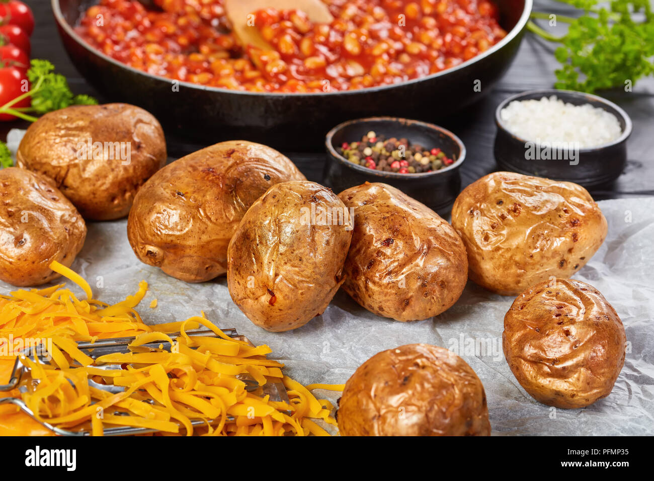 baked potato with grated cheese on paper Stock Photo