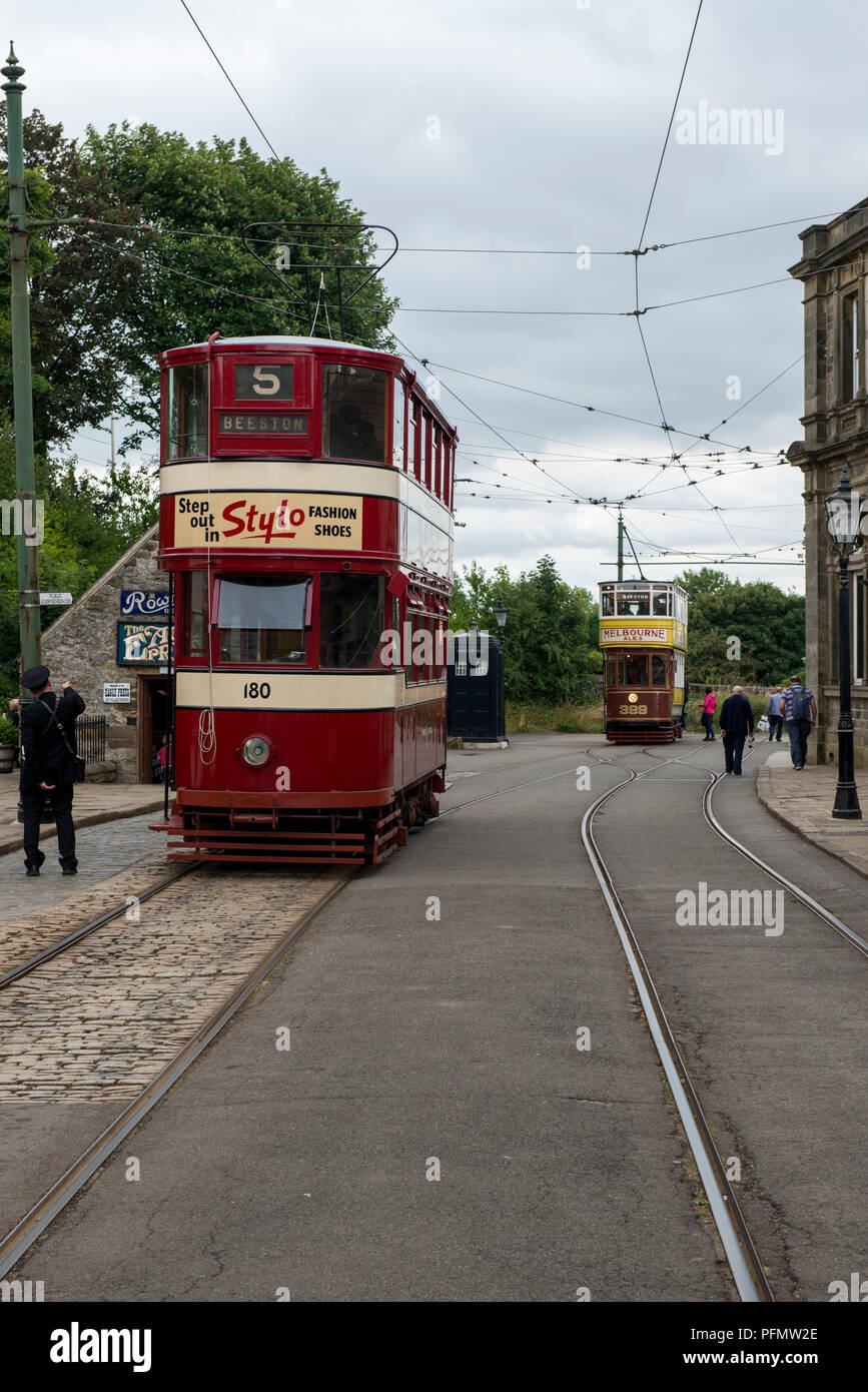 Leeds trams No 180 and 399 on route at Crich Tramway Village Debyshire 19/08/2018 Stock Photo