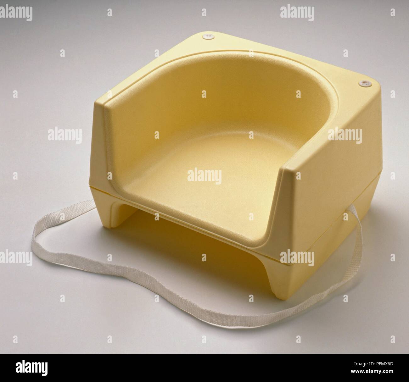 Yellow plastic booster seat Stock Photo Alamy