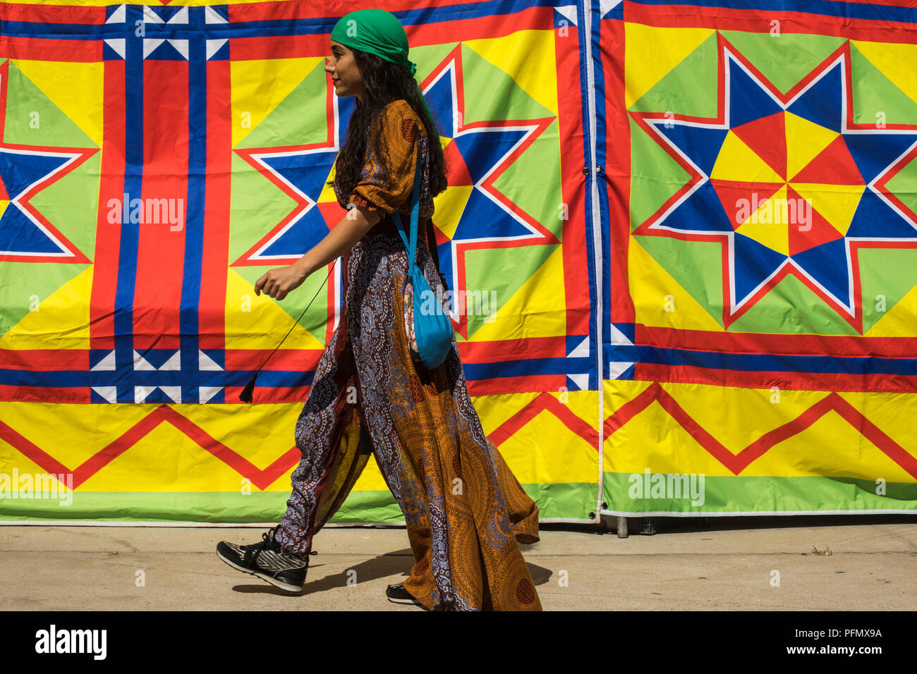 Attendees walk by a colorful tent at the Festival of the Chariots, August 5, 2018, (The Hare Krishna Festival), Venice Beach, Los Angeles, California, Stock Photo