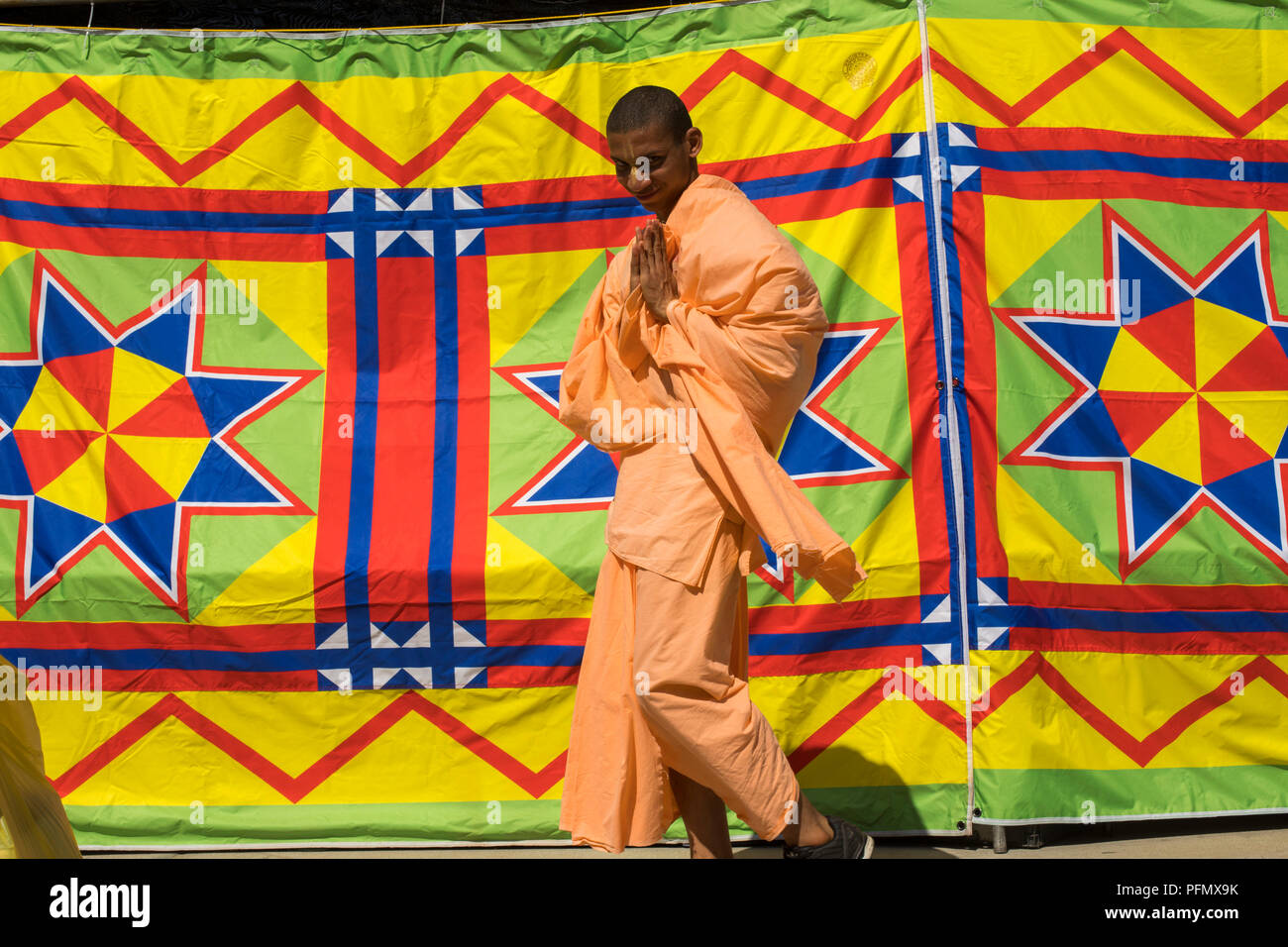 Attendees walk by a colorful tent at the Festival of the Chariots, August 5, 2018, (The Hare Krishna Festival), Venice Beach, Los Angeles, California, Stock Photo