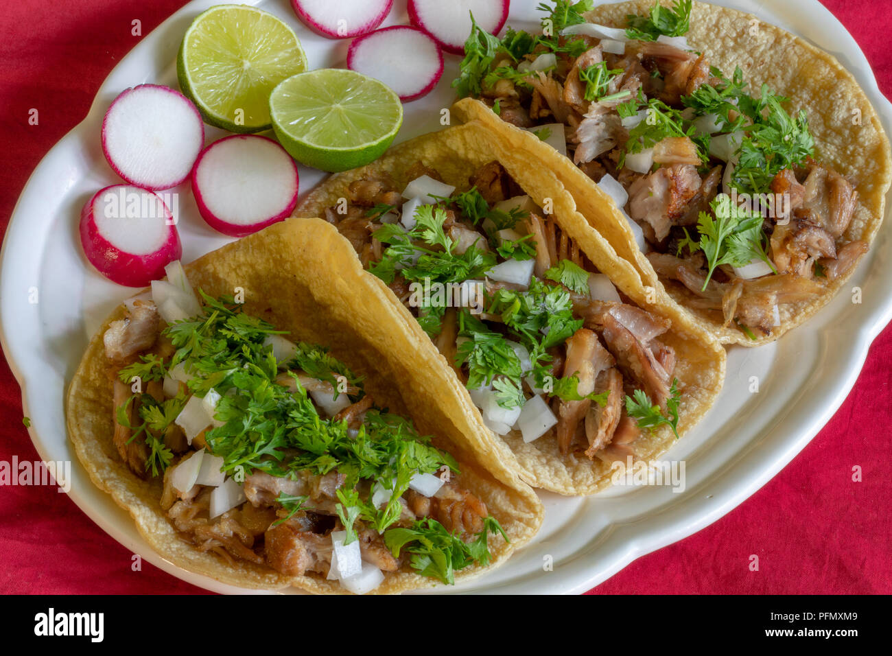 Carnitas Tacos, Tacos made with pork meat onions, cilantro, lemon and radish Stock Photo