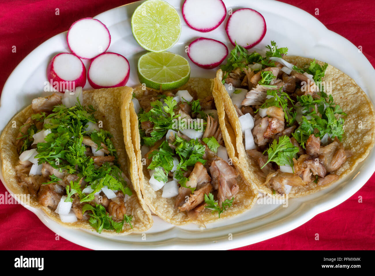 Carnitas Tacos, Tacos made with pork meat onions, cilantro, lemon and radish Stock Photo