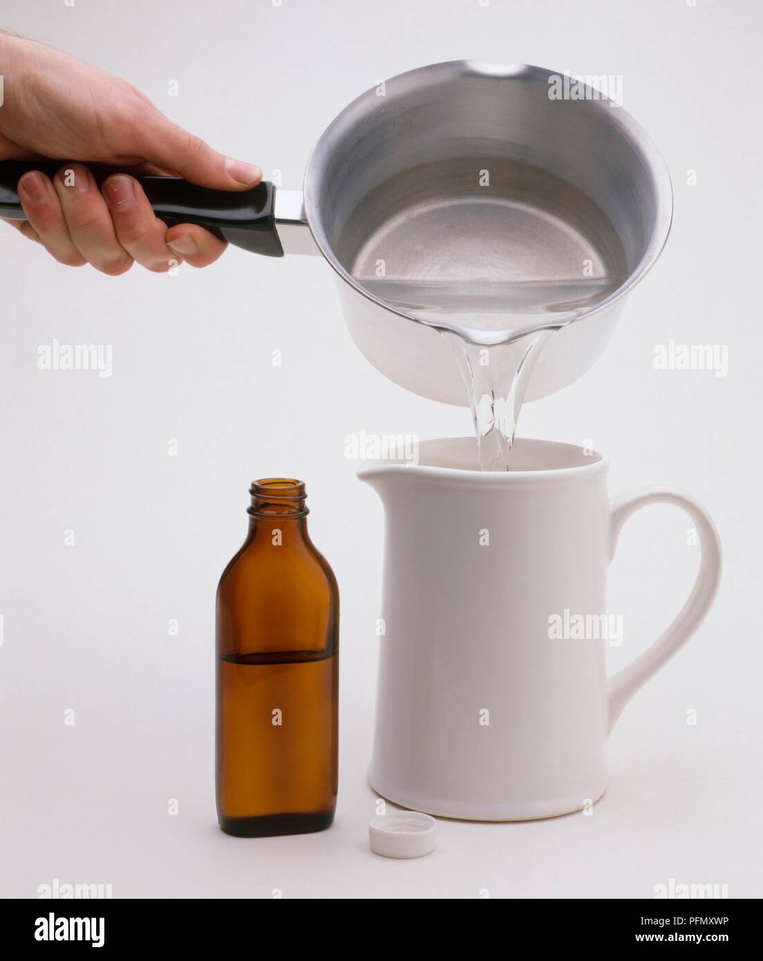Person pouring glycerin solution in jug Stock Photo Alamy