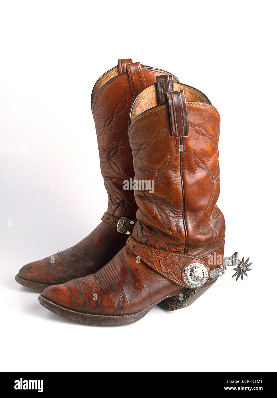 Pair of brown leather cowboy boots with spurs Stock Photo