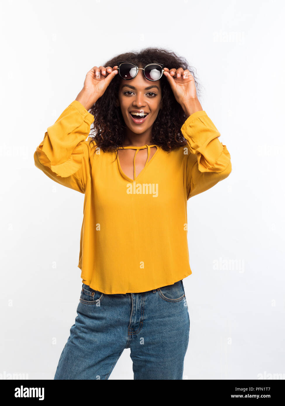 Beautiful African American Woman With Afro Hair In Yellow Wear And