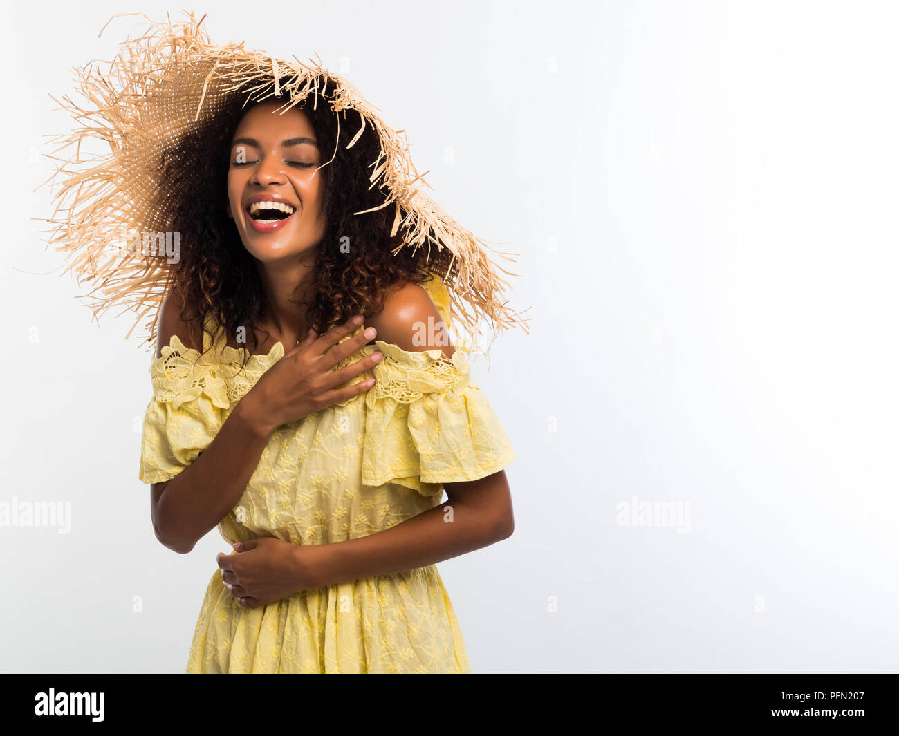 Happy African American Woman With Curly Afro Hair In Yellow Dress