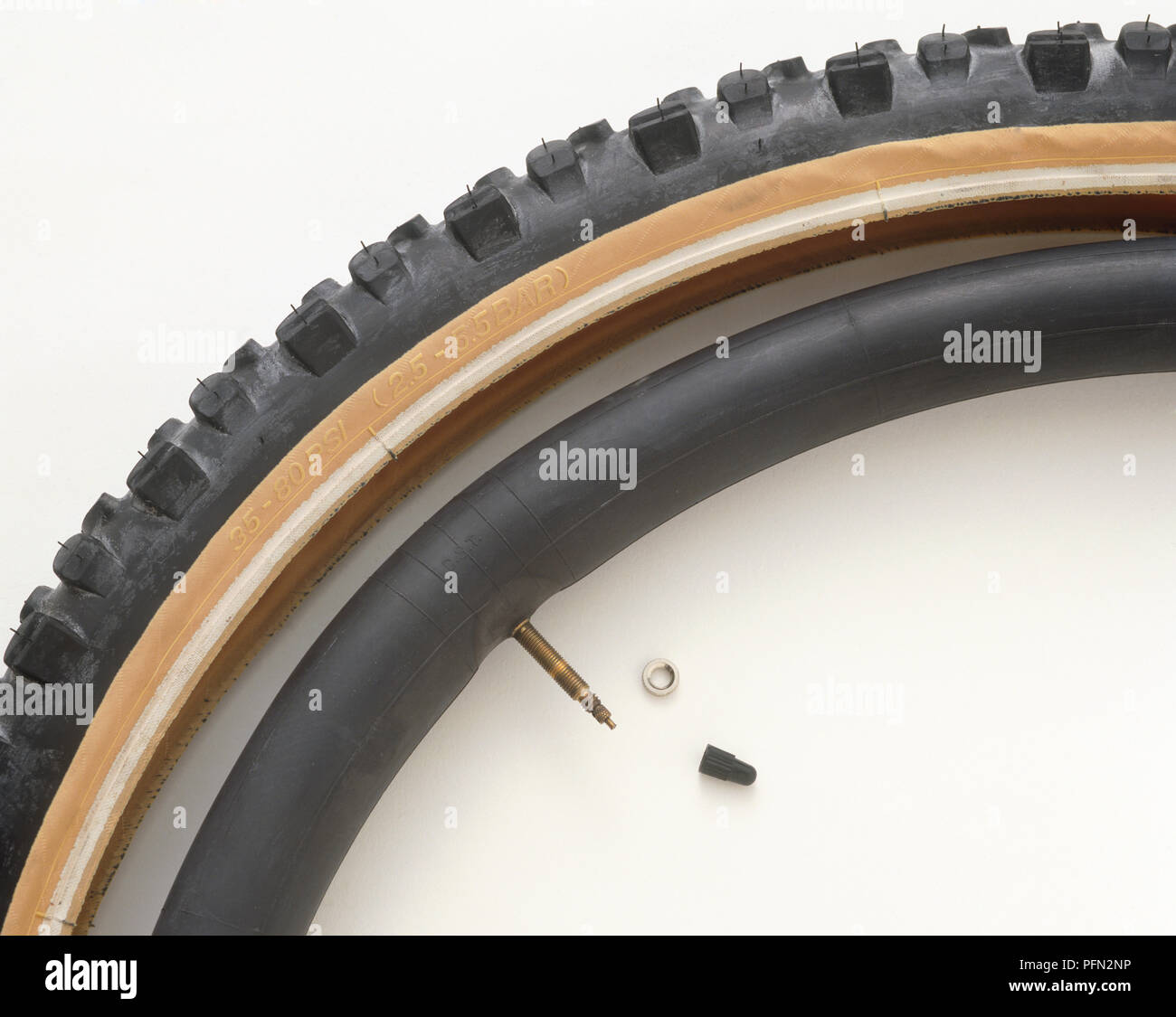 Bicycle tyre, inner tube, valve lockring, and valve dustcap Stock Photo