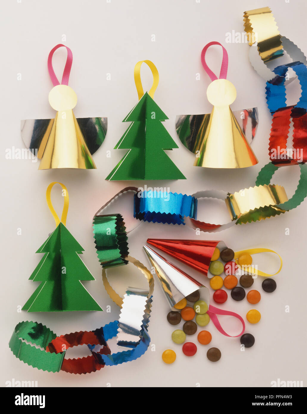 Selection Of Handmade Christmas Decorations Made From Shiny Coloured Paper Including Angels And Paper Chains Stock Photo Alamy