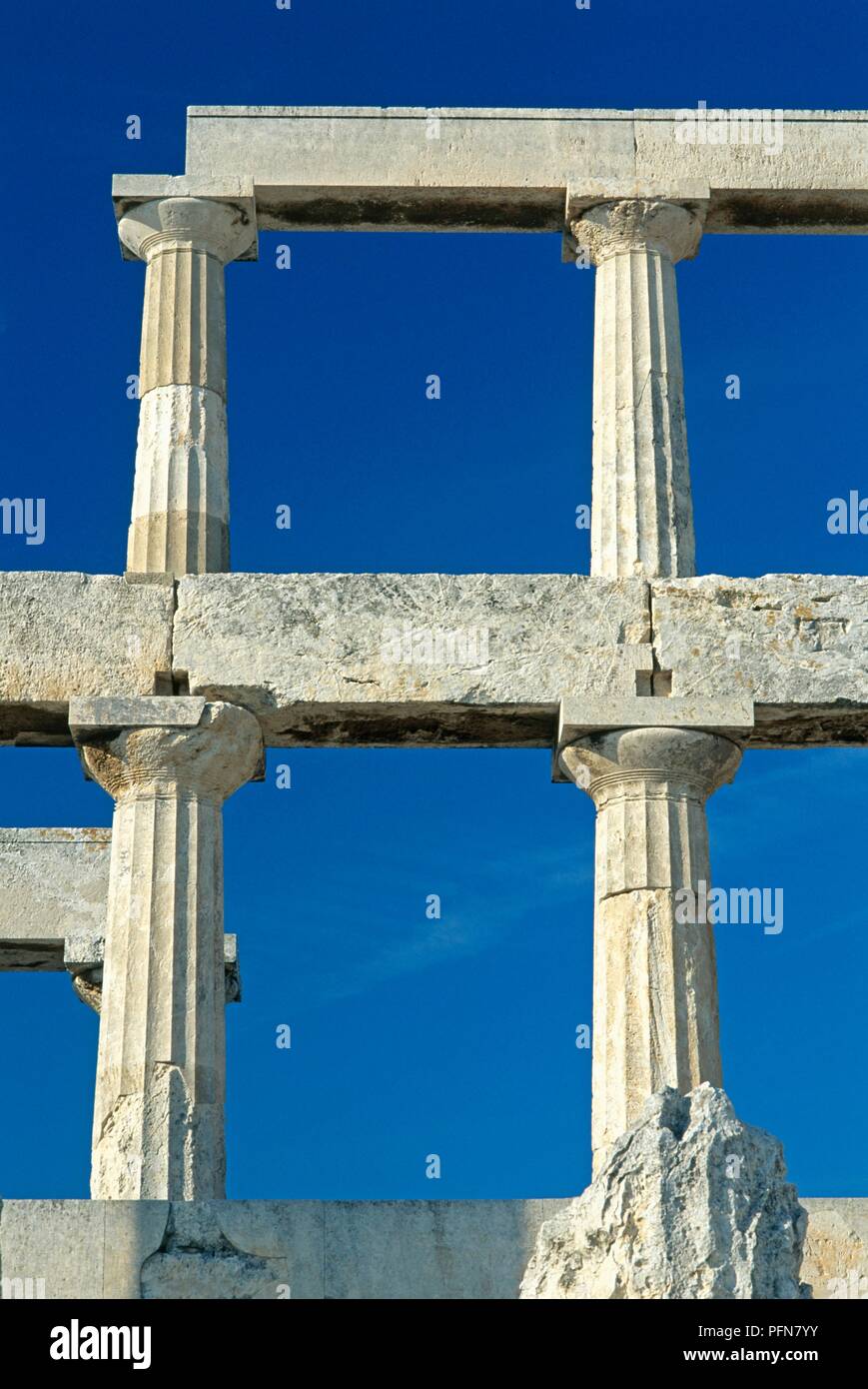 Greece, Aegina, Temple of Aphaia, two storeys of Doric columns set against clear blue sky Stock Photo